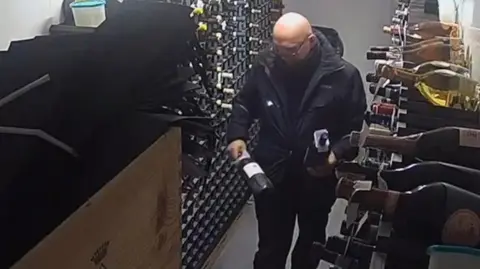 Iuliu Kubola in a wine cellar handling stolen goods