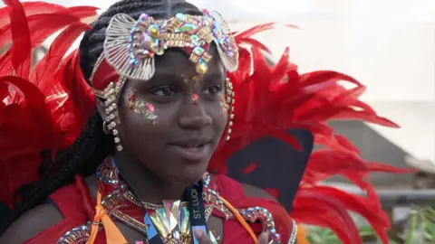 Colourful young girl in red carnival outfit