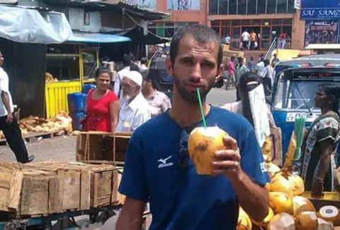Boichenko family Volodymyr drinking from a coconut