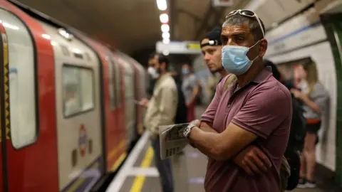 AFP Commuters wearing face masks on Tube