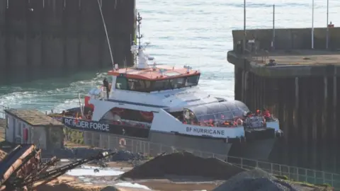 A group of people thought to be migrants are brought in to the Border Force compound in Dover, Kent, onboard a Border Force vessel.